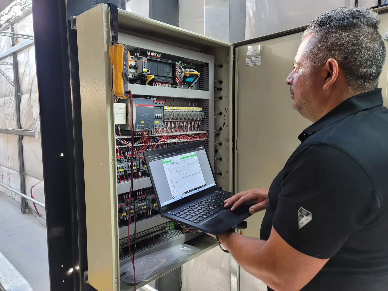 Technician servicing automated parking controls