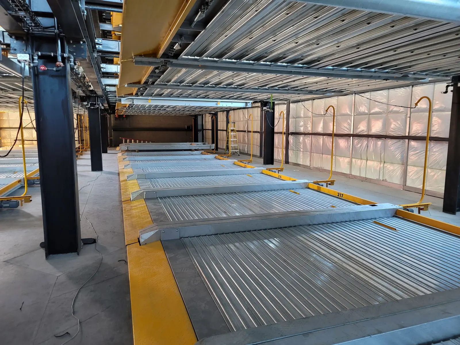 Parking stacker system inside a multifamily garage