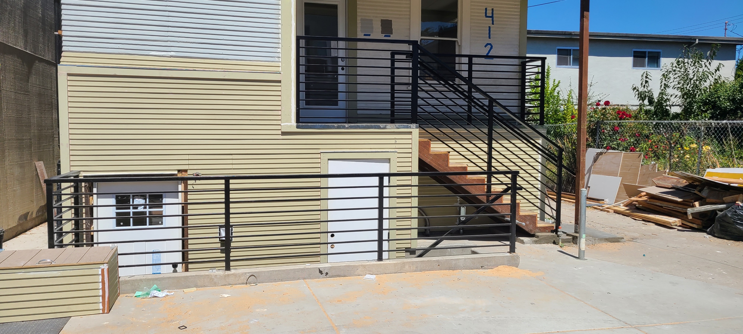 Black ornamental metal railing installation outside a home